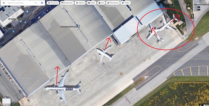 Strange Google Earth find of planes on a tarmac with red arrows and circles highlighting their positions.