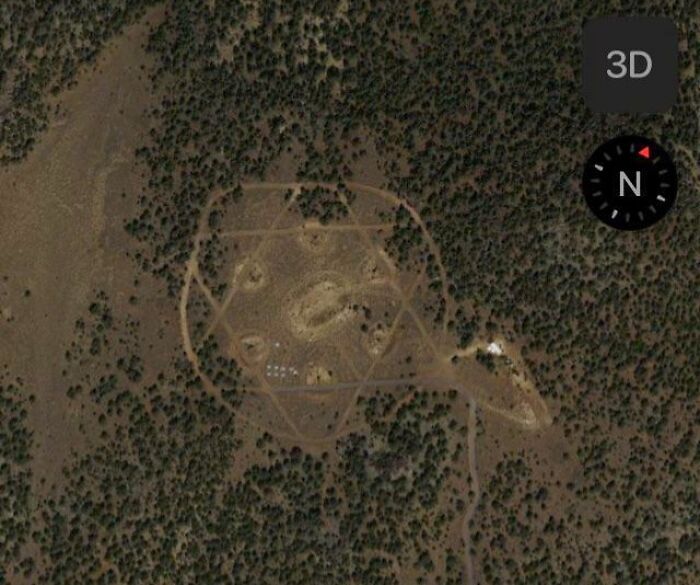Aerial view of a strange geometric formation in a forest captured on Google Earth.