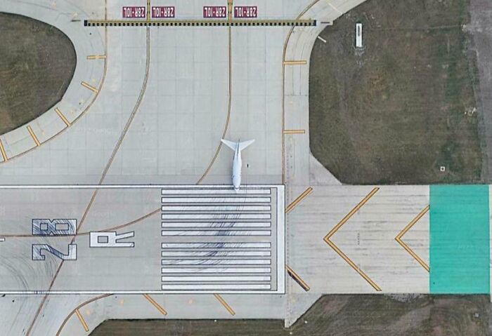 Aerial view of airplane parked on runway, a strange find on Google Earth.