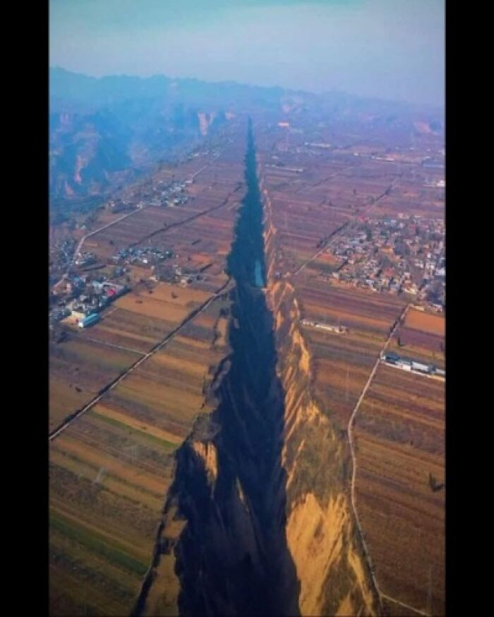 Aerial view of a deep, long gorge cutting through farmland, showcasing preserved geological features from ancient explorers.