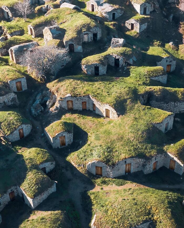 Ancient explorers' cave dwellings with grass-covered roofs, showcasing historical preservation from the past.