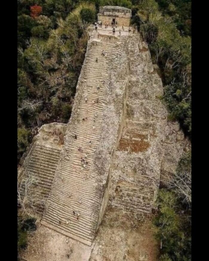 Ancient explorers captured a tall stone pyramid with steps surrounded by dense greenery.