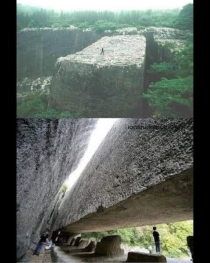 Giant ancient stone structure explored by people, showcasing preserved historical craftsmanship.