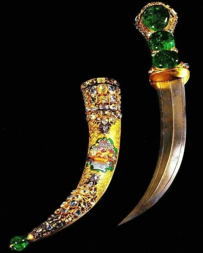 Ancient explorers' ornate dagger with a jeweled hilt and sheath, featuring intricate gold and gemstones design.