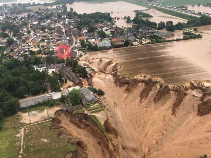 Aerial view of severe flooding and massive landslide highlighting nature's powerful and terrifying impact on a town.