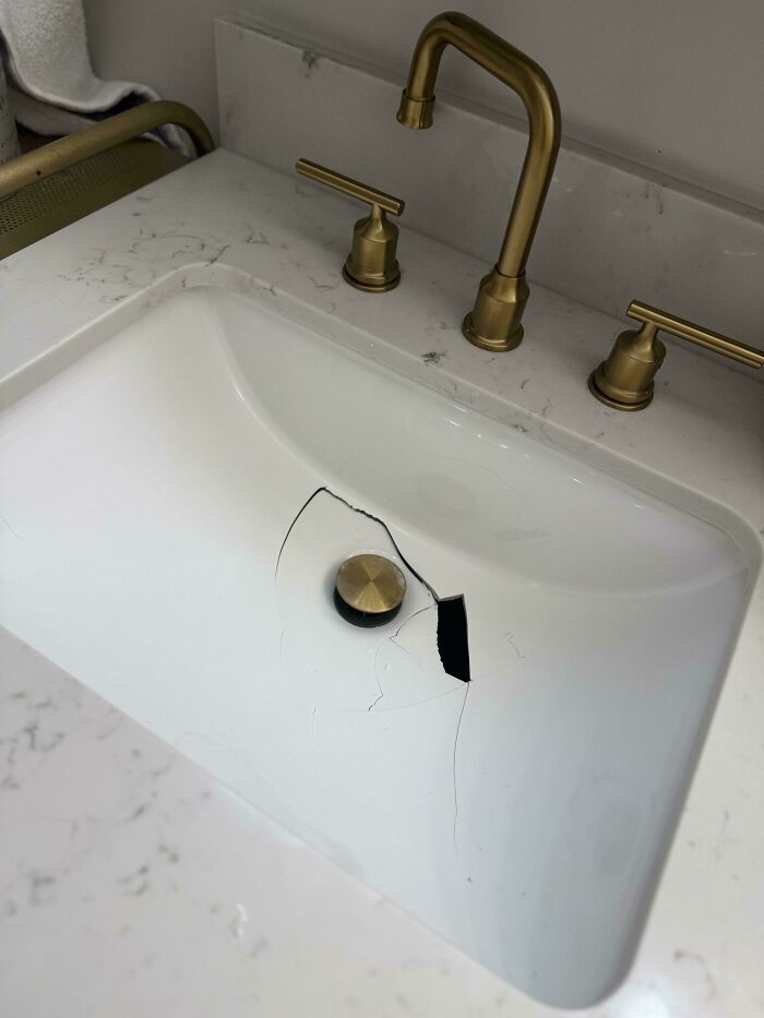 C*****d bathroom sink with brass faucet, highlighting expensive accidents.