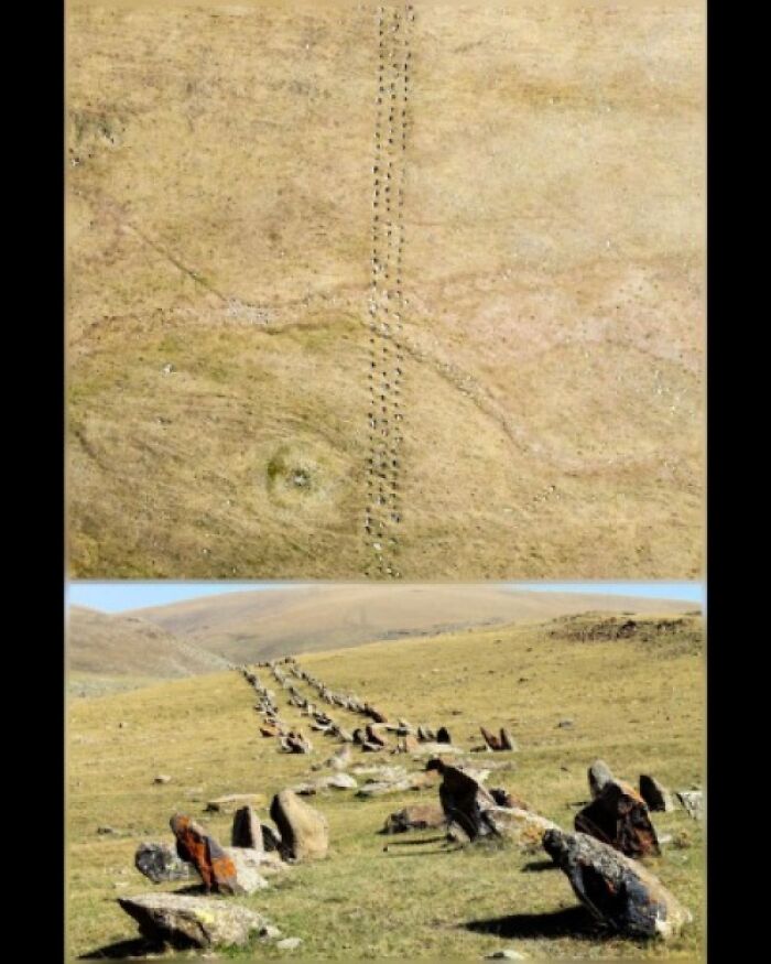 Stone arrangement on a grassy hill, showcasing ancient explorers' paths and preserved historic artifacts.