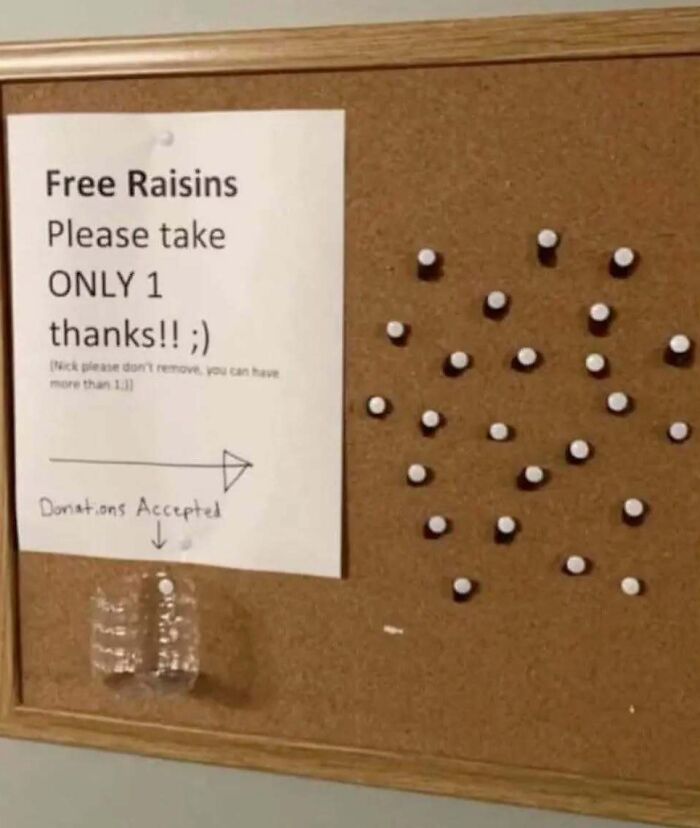 Bulletin board with a sign offering free raisins pinned with thumbtacks, representing chaotic food humor.