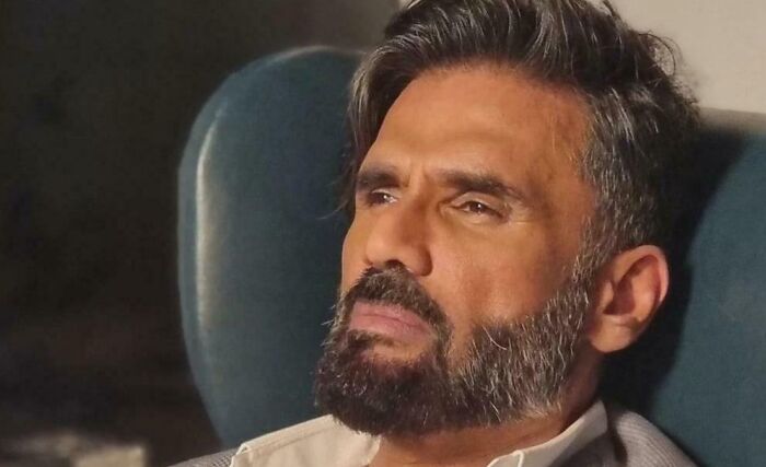 Indian actor sitting thoughtfully, highlighting fascinating facts about his humanitarian effort to help Nepalese women in 1996.