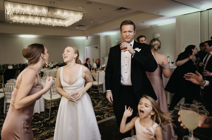 Elegant wedding scene with guests in formal attire, resembling an accidental Renaissance painting.