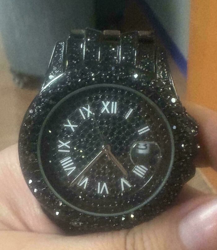 Black watch with sparkling stones and incorrect Roman numerals, showing a hilarious perfectly preventable fail.