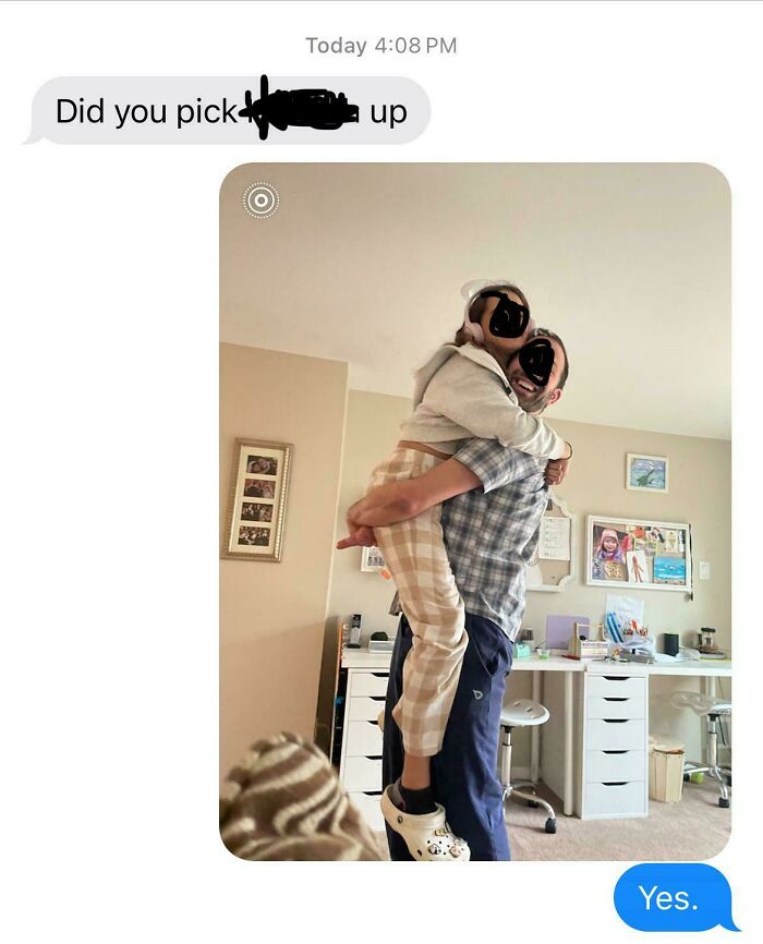 Dad lifting child in a warm embrace at home, capturing a wholesome parenting moment full of love and joy.