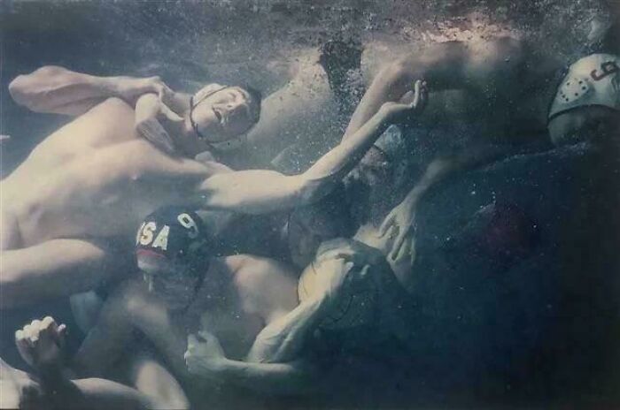 Water polo players creating an accidental renaissance scene underwater, capturing a dramatic and artistic moment.
