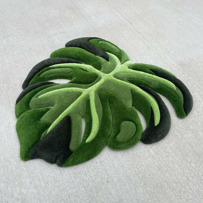 DIY project: leaf-shaped green rug resembling monstera foliage on a light surface.