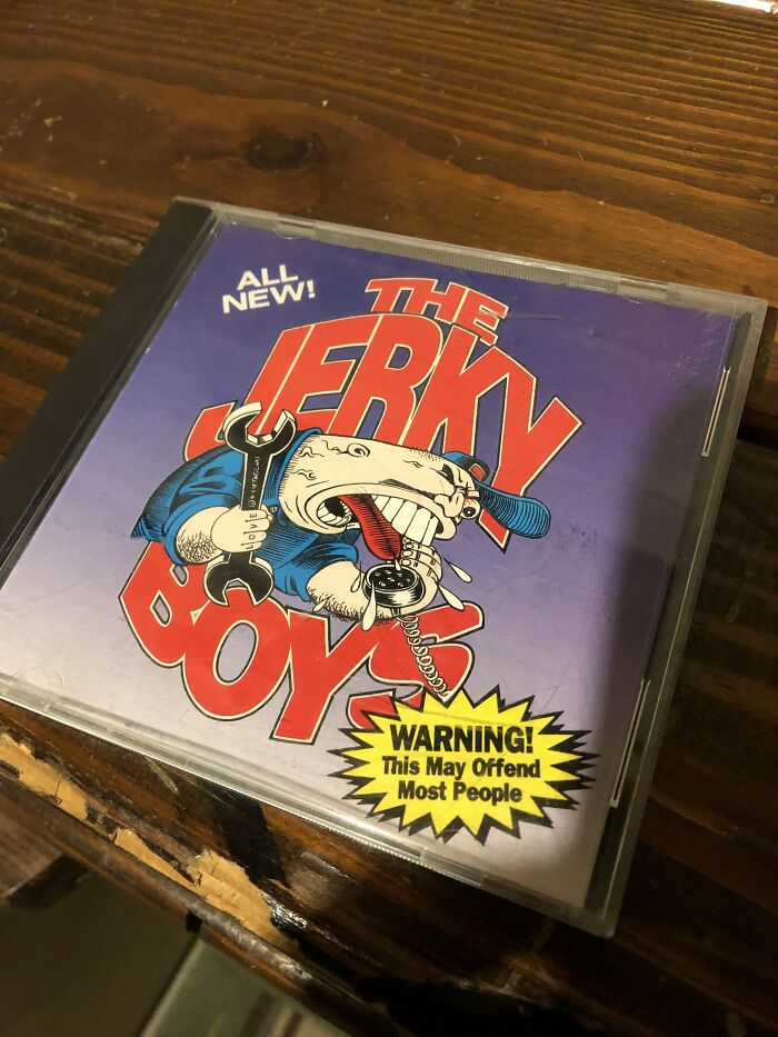 CD case of The Jerky Boys comedy album on a wooden surface, evoking nostalgic 90s memories and humor.