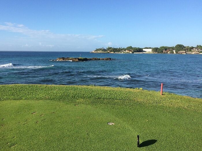 Scenic golf course by the ocean, showcasing breathtaking views golfers travel worldwide to experience.