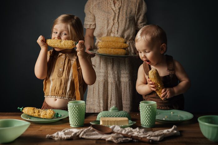 Children joyfully eating corn, captured through a mother's lens showcasing the magic of childhood moments.