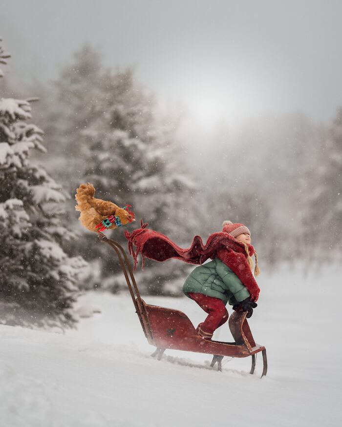 Childhood magic captured through a mother's lens: a child joyfully sledding in snowy forest with a teddy bear.