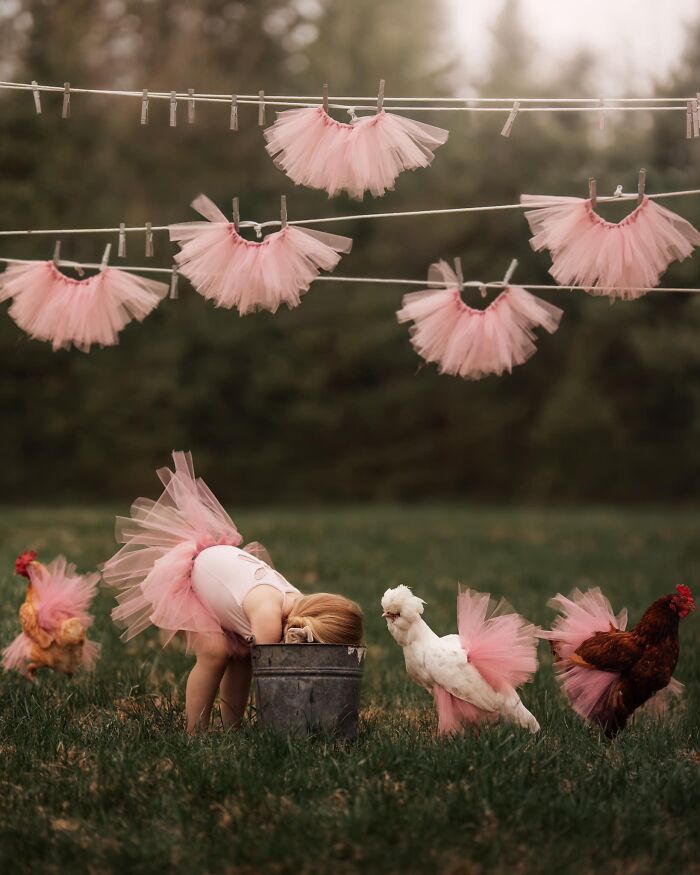 Child in a pink tutu peers into a bucket, surrounded by chickens in tutus, capturing the magic of childhood.