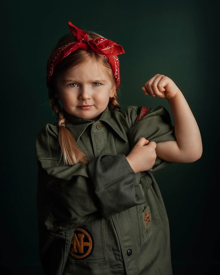 Childhood magic captured through a mother’s lens: a young girl in green jacket and red bandana posing confidently.