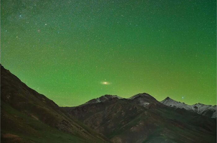 Night sky astrophotography featuring a glowing Andromeda over rugged mountains by Soumyadeep Mukherjee.