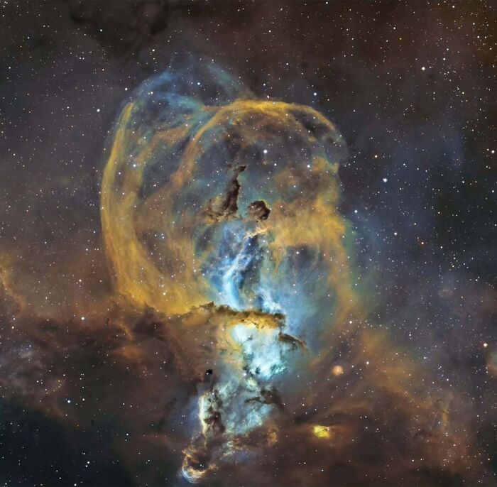 Astrophotography: a stunning capture of a colorful nebula with stars scattered across the night sky.