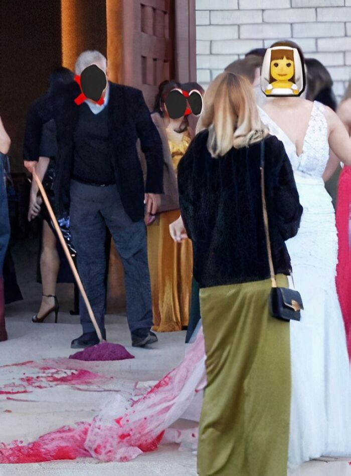 Man sweeping red spill at chaotic wedding scene outside venue.