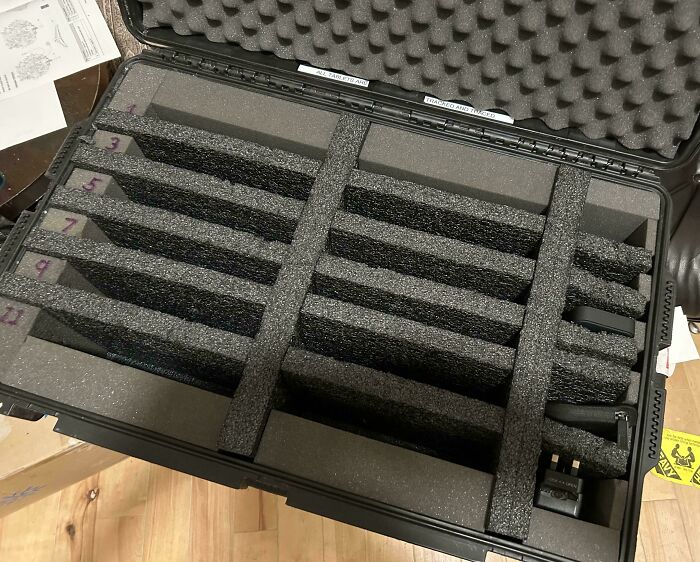 Open suitcase with empty foam insert slots, highlighting epic airline baggage fail.