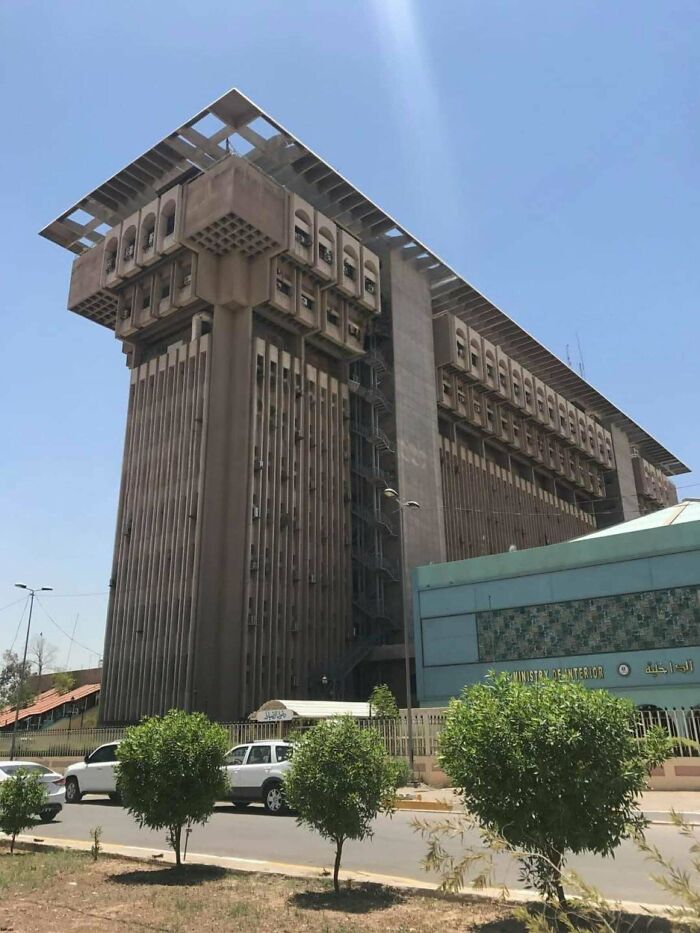 Brutalist building with an imposing, eerie design that gives off a supervillain headquarters vibe under clear skies.