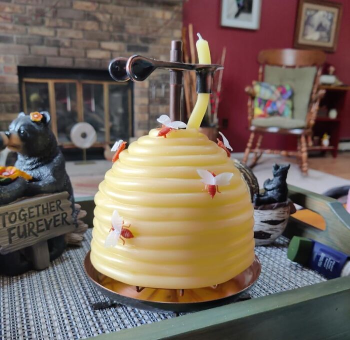 Yellow bee-shaped candle holder with bees, a charming Amazon find adding joy to a cozy living room setting.