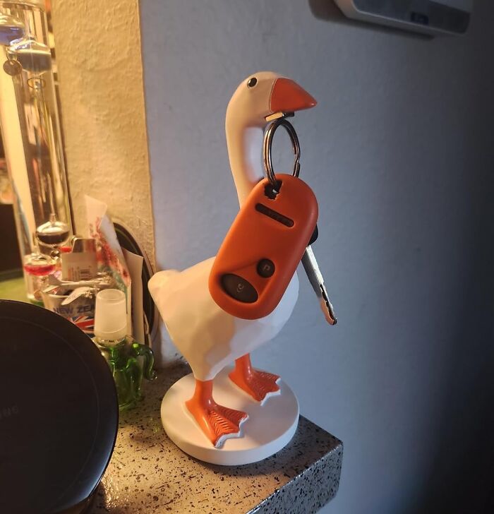 Goose-shaped key holder with an orange car key attached, a fun Amazon find sparking joy.