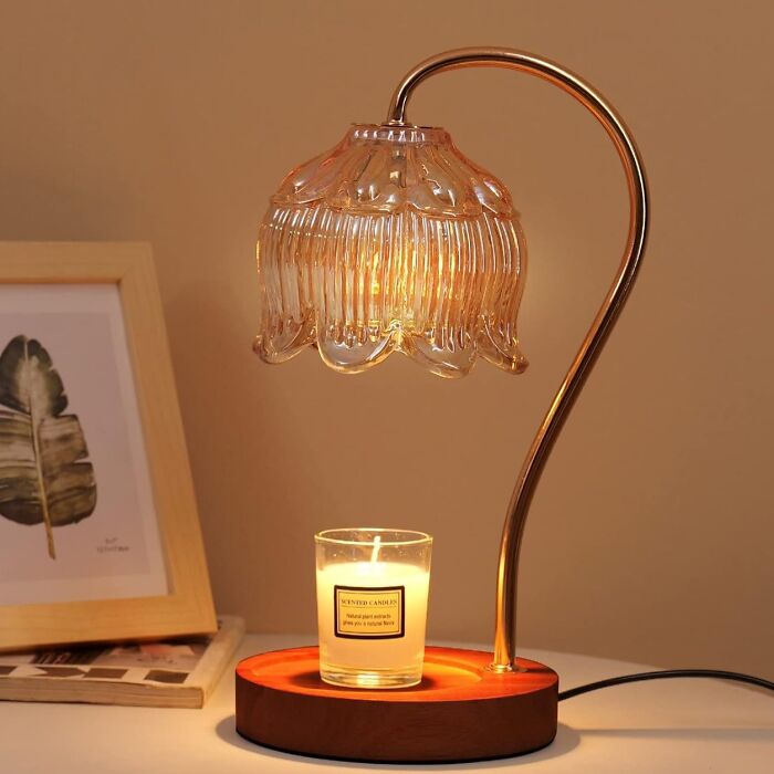 Decorative table lamp with glass floral shade and wooden base holding a scented candle, popular TikTok shop find.