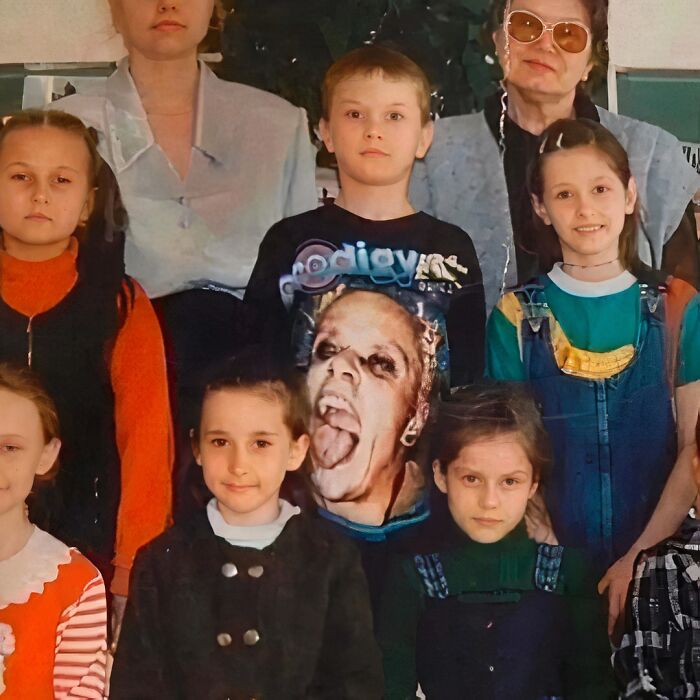 Child wearing chaotic T-shirt with a bold graphic in a retro group photo.