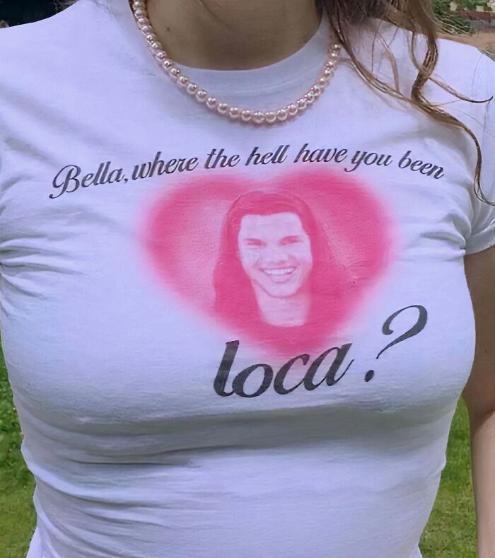 Chaotic T-shirt with "Bella, where the hell have you been loca?" printed, featuring a smiling face in a pink heart.