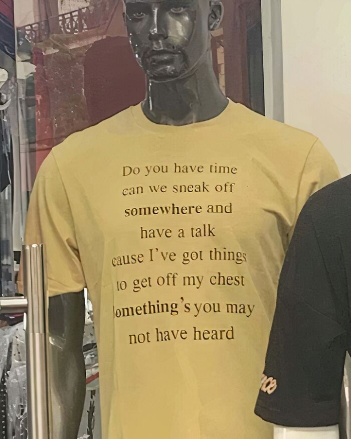Mannequin wearing a chaotic T-shirt with humorous text in a store display.