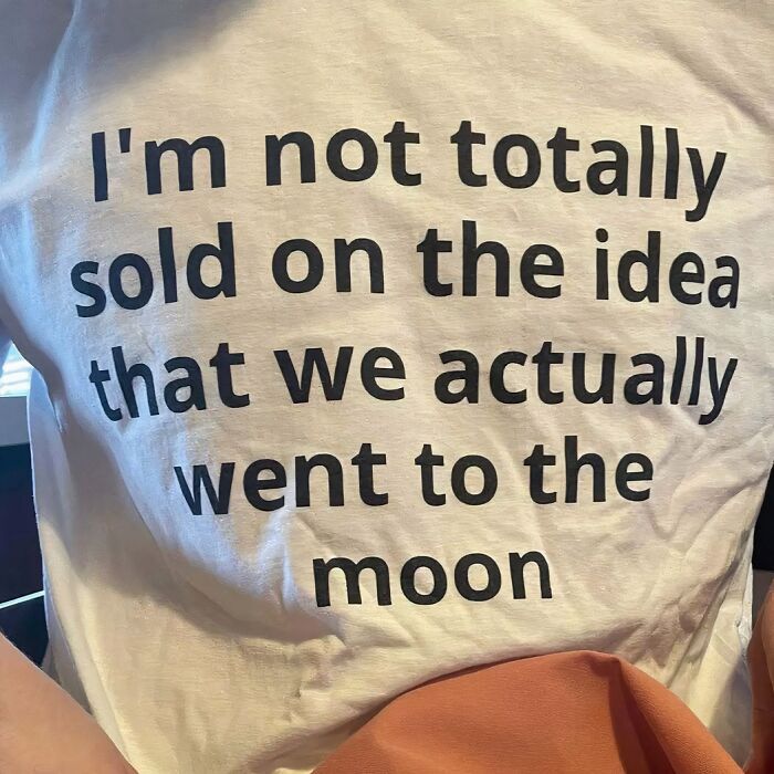T-shirt with bold text expressing doubt about the moon landing, showcasing a chaotic design that speaks the truth.
