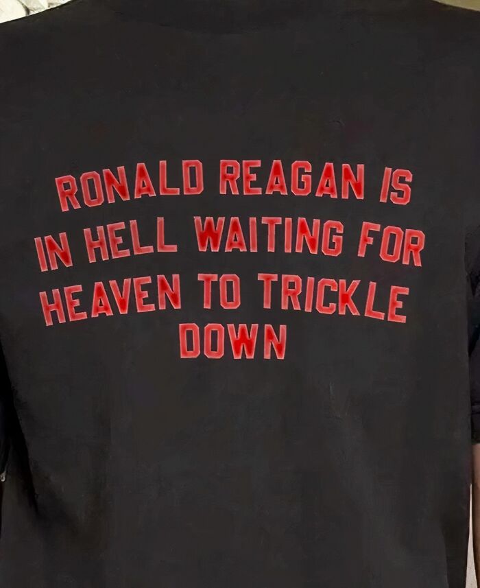 Chaotic T-shirt with bold red text on a black background expressing a controversial political statement.