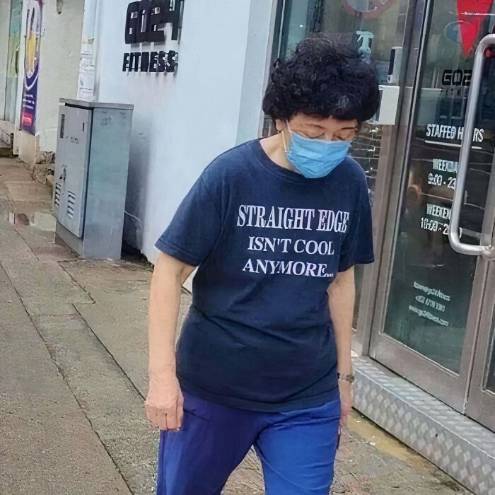 Person wearing a blue mask and chaotic T-shirt saying "STRAIGHT EDGE ISN'T COOL ANYMORE."