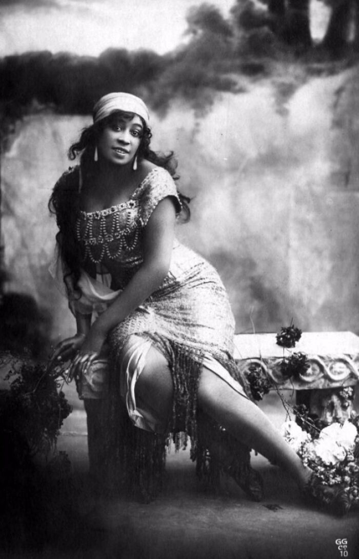 Vintage portrait of a woman sitting, showcasing early 20th-century fashion and style changes.