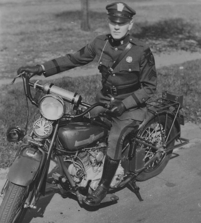 Vintage photo of a police officer on a classic motorcycle, illustrating how much the world has changed over 50-100 years.