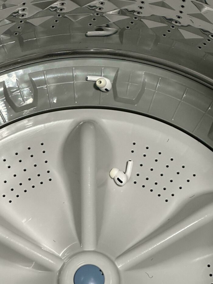 AirPods accidentally left inside a washing machine drum after an expensive mishap.