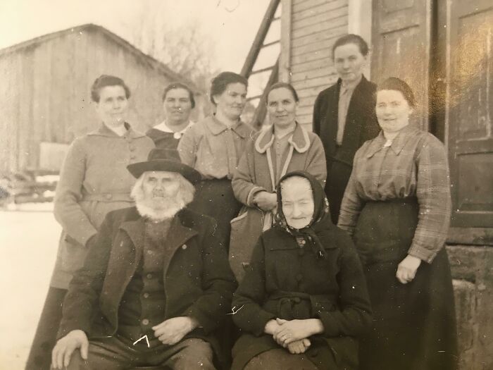 Vintage group photo from 50-100 years ago, showing family members in traditional attire, illustrating historical change.