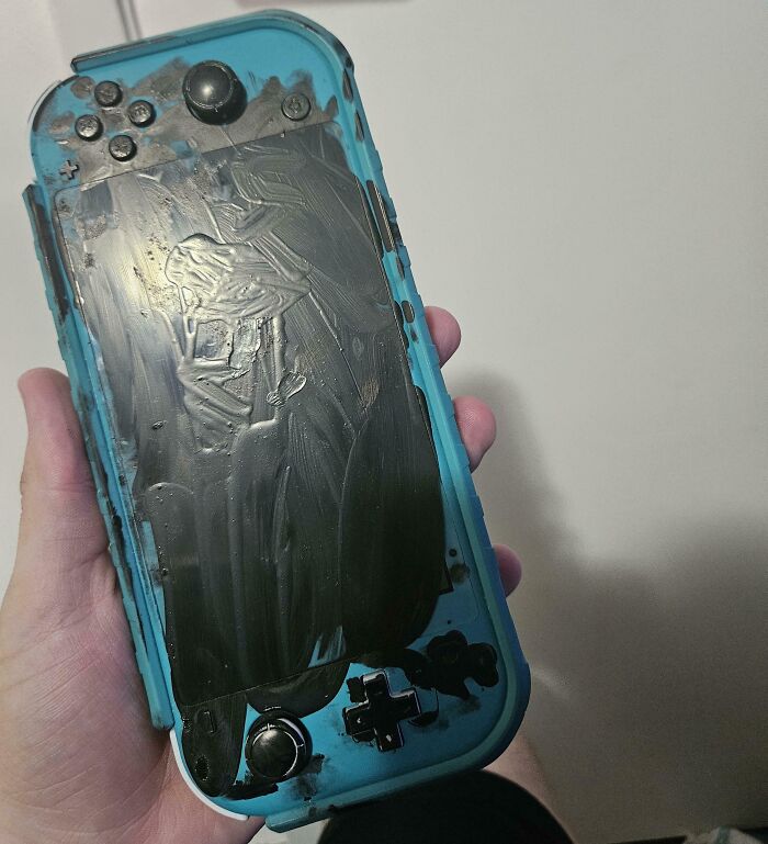 Damaged gaming console with melted screen, highlighting an expensive accident.