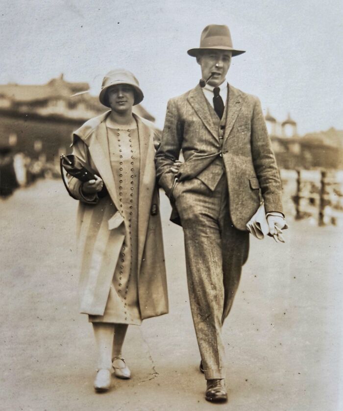 Vintage couple walking in elegant 1920s fashion, showcasing rare style from 50-100 years ago.