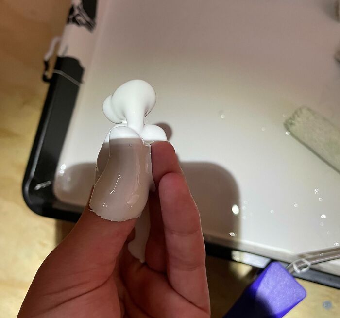 Hand covered in white paint, illustrating an expensive accident.