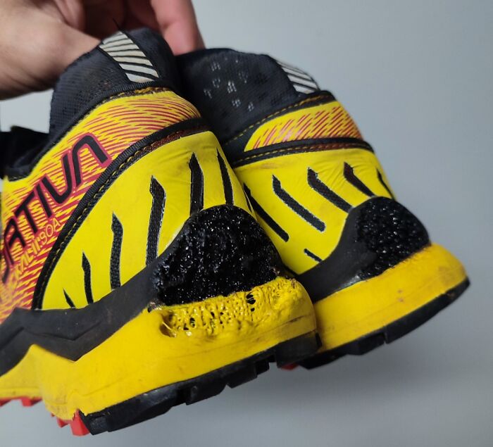 Damaged yellow sneakers with black scorch marks, illustrating expensive accidents.