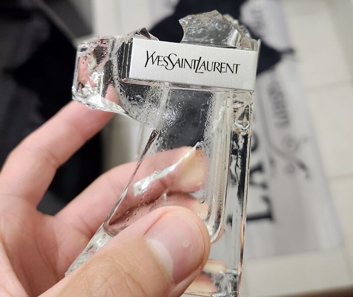 Broken Yves Saint Laurent bottle, reflecting a super expensive accident.