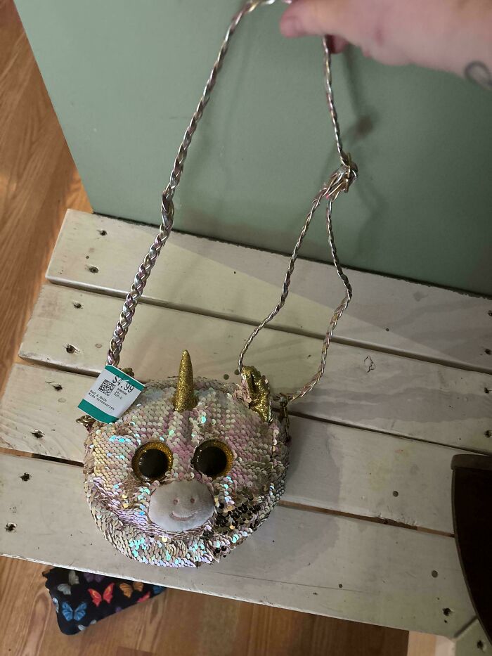 Sequin-covered unicorn purse with golden horn and ears, a popular thrift store find priced at $4.99.