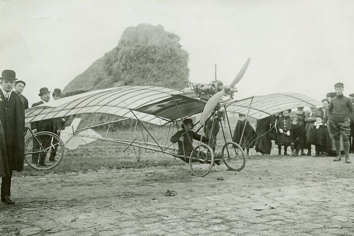 Rare historical photo of an early aircraft with onlookers, illustrating significant changes in aviation technology.