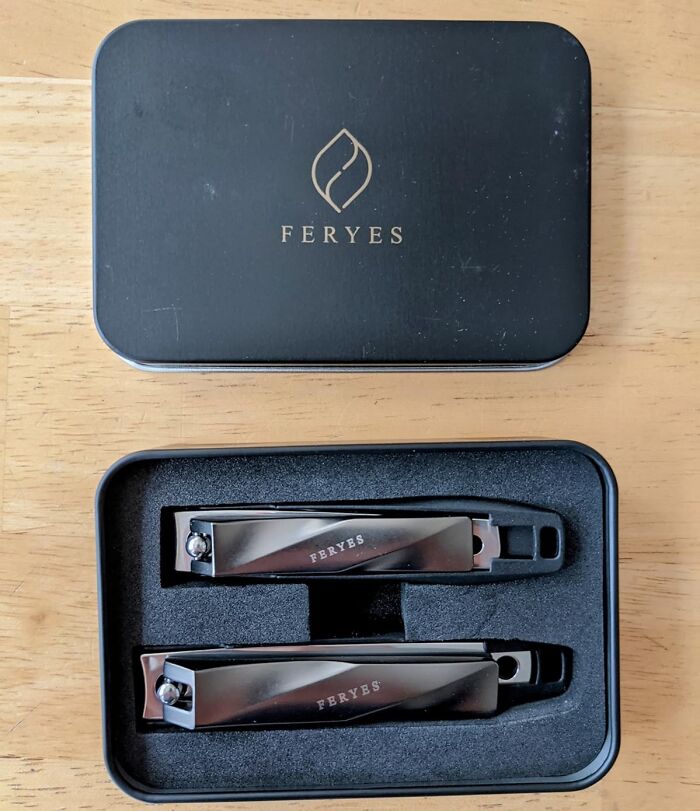 Nail clippers in a Feryes metal case on a wooden table, emphasizing ultra-specific product design.